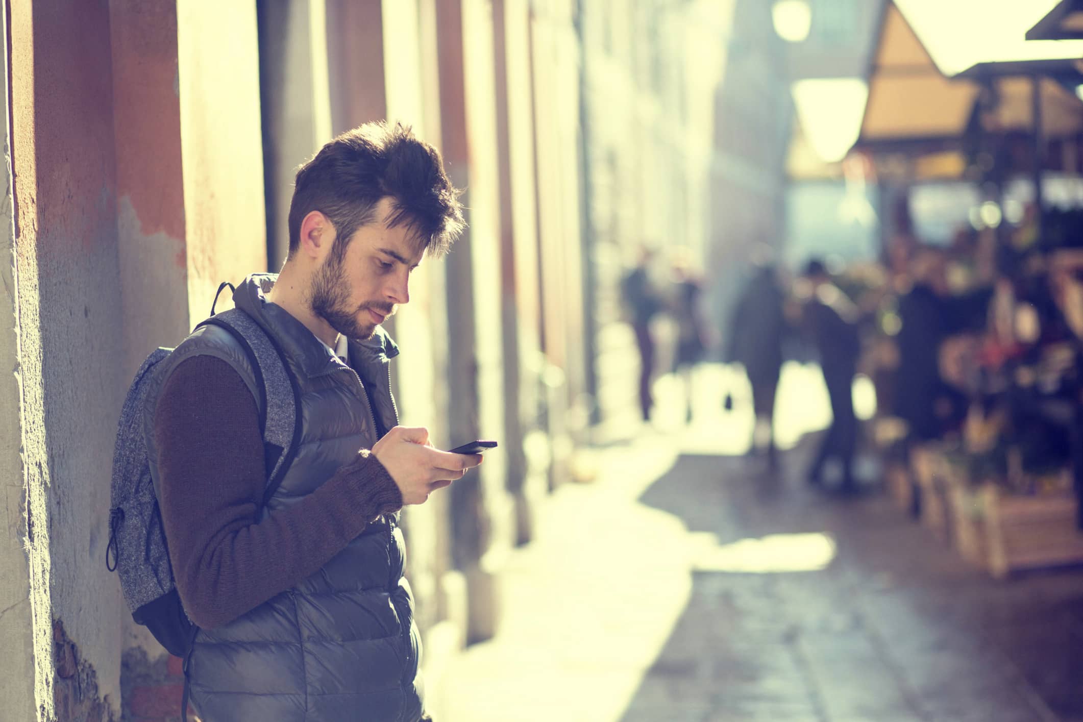 Casual man texting on mobile phone