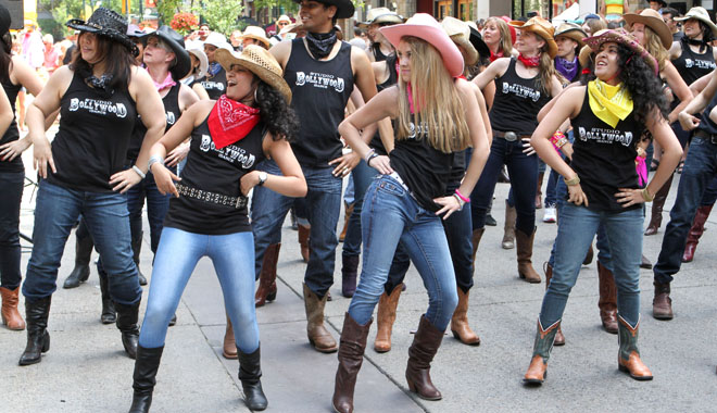 CALGARY, AB : JULY 8, 2012 - Anshula Ambasta, left, Jamie Luchak and Shreya Ambasta were three of the dancers who took part as local Bollywood choreographers hosted a flash mob on Stephen Avenue Mall to help celebrate the 100th anniversary of the Calgary Stampede on July 8, 2012. (Lorraine Hjalte/Calgary Herald) (For City/Stampede story by Valerie Fortney) 10038941A